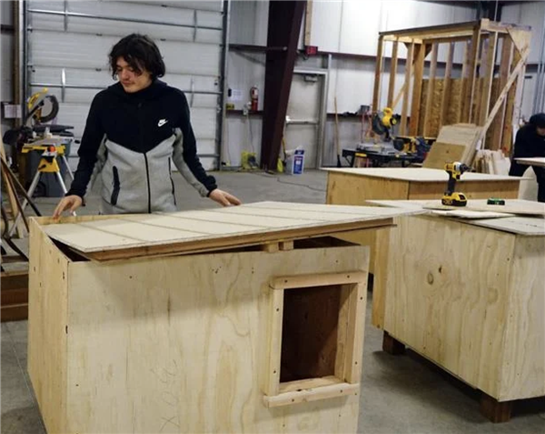 Carpentry class partners with Straw For Dogs to build doghouses